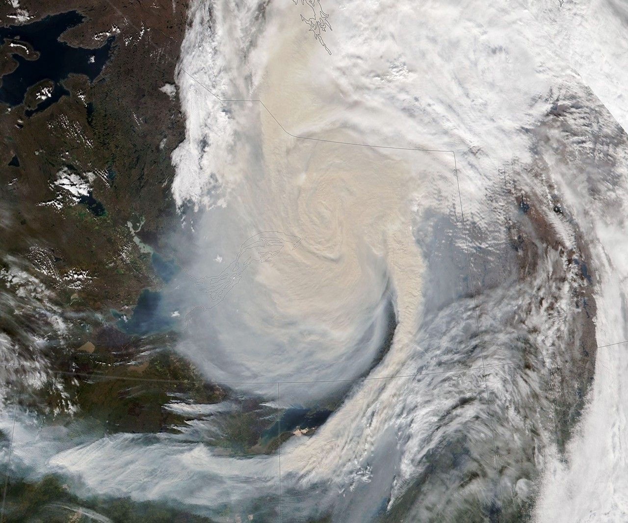 VIIRS true-color satellite image showing a dramatic spiral of wildfire smoke over the Northwest Territories, September 2023